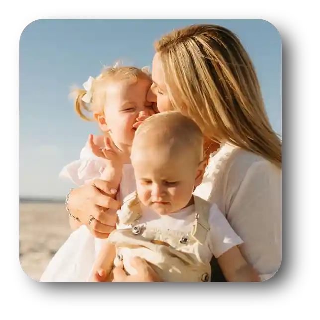Chelsea at the beach with her two young children
